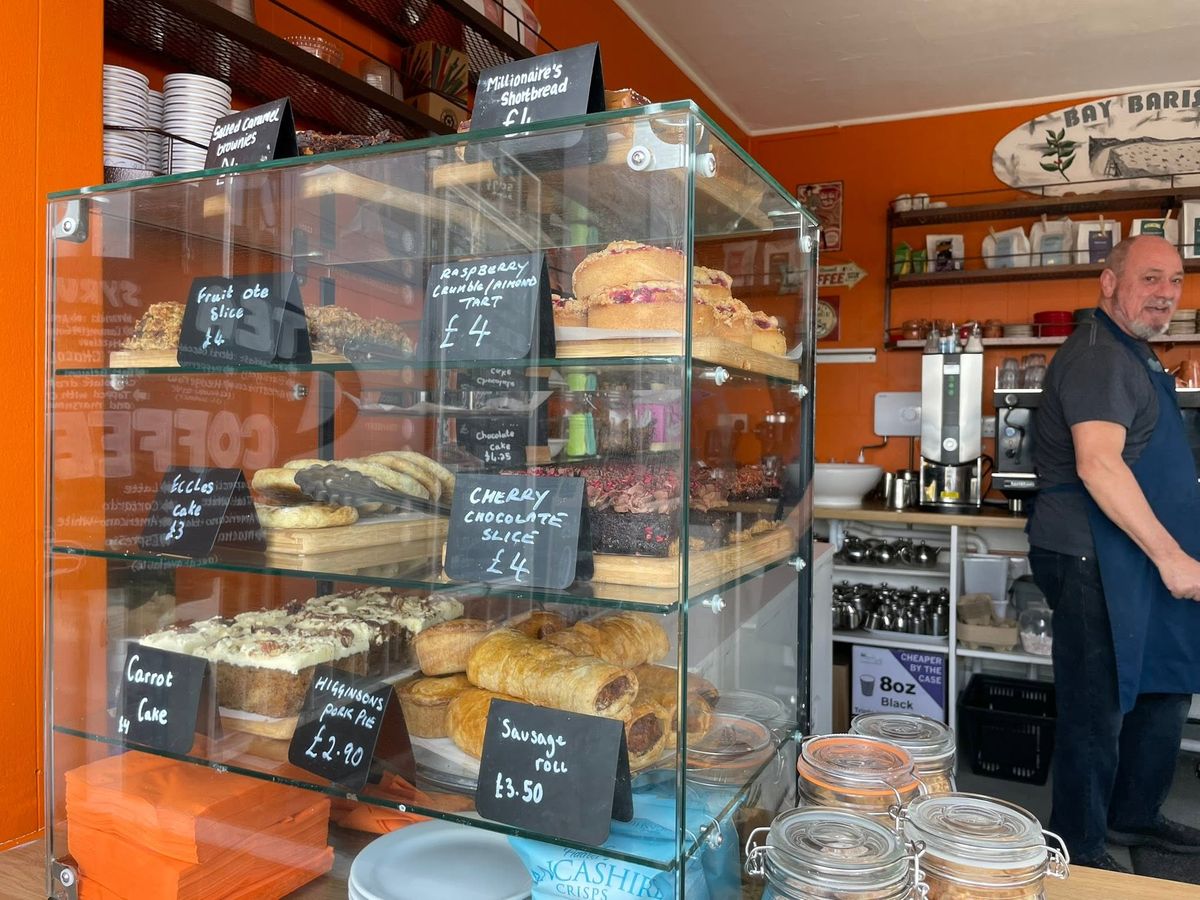 The cake cabinet at Bay Baristas with carrot cake, Eccles cakes and pork pies